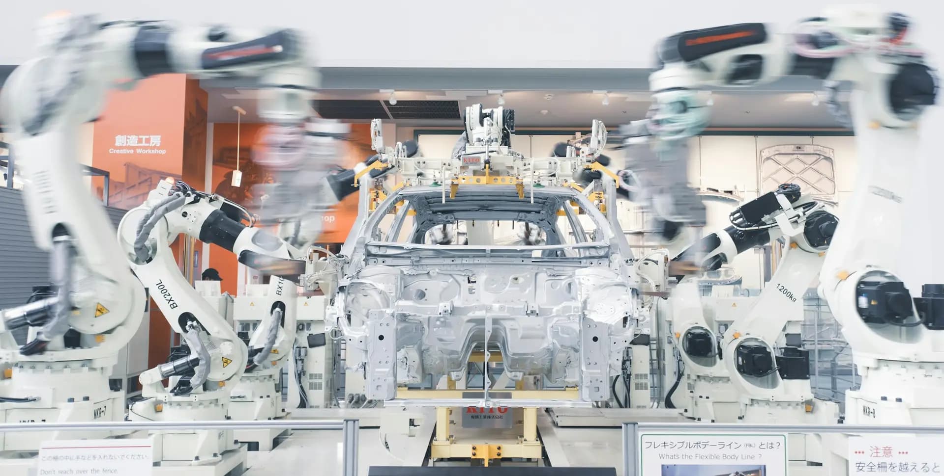 Robotic arms assembling a car body on a production line