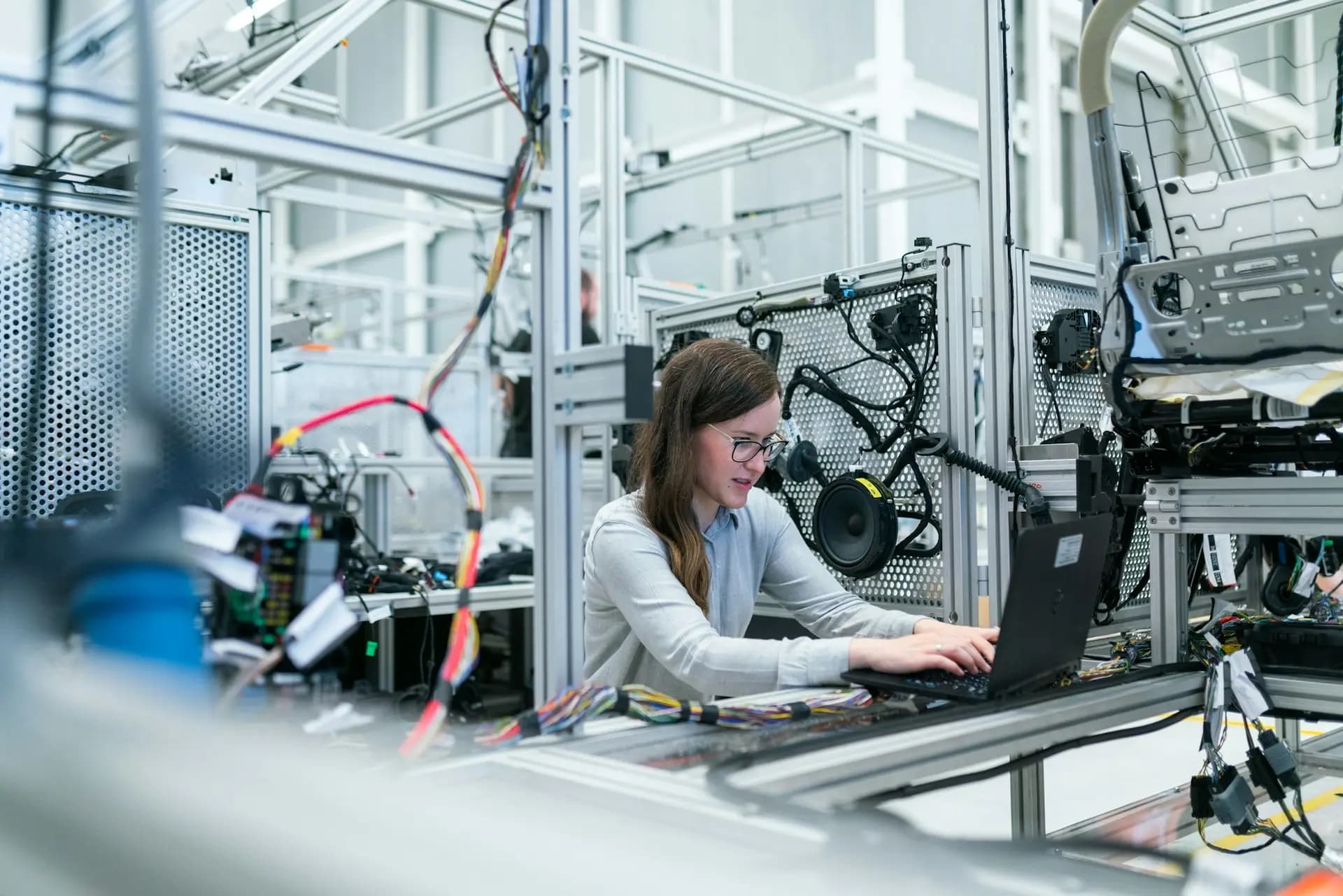 Engineer using a laptop at an automation test rig