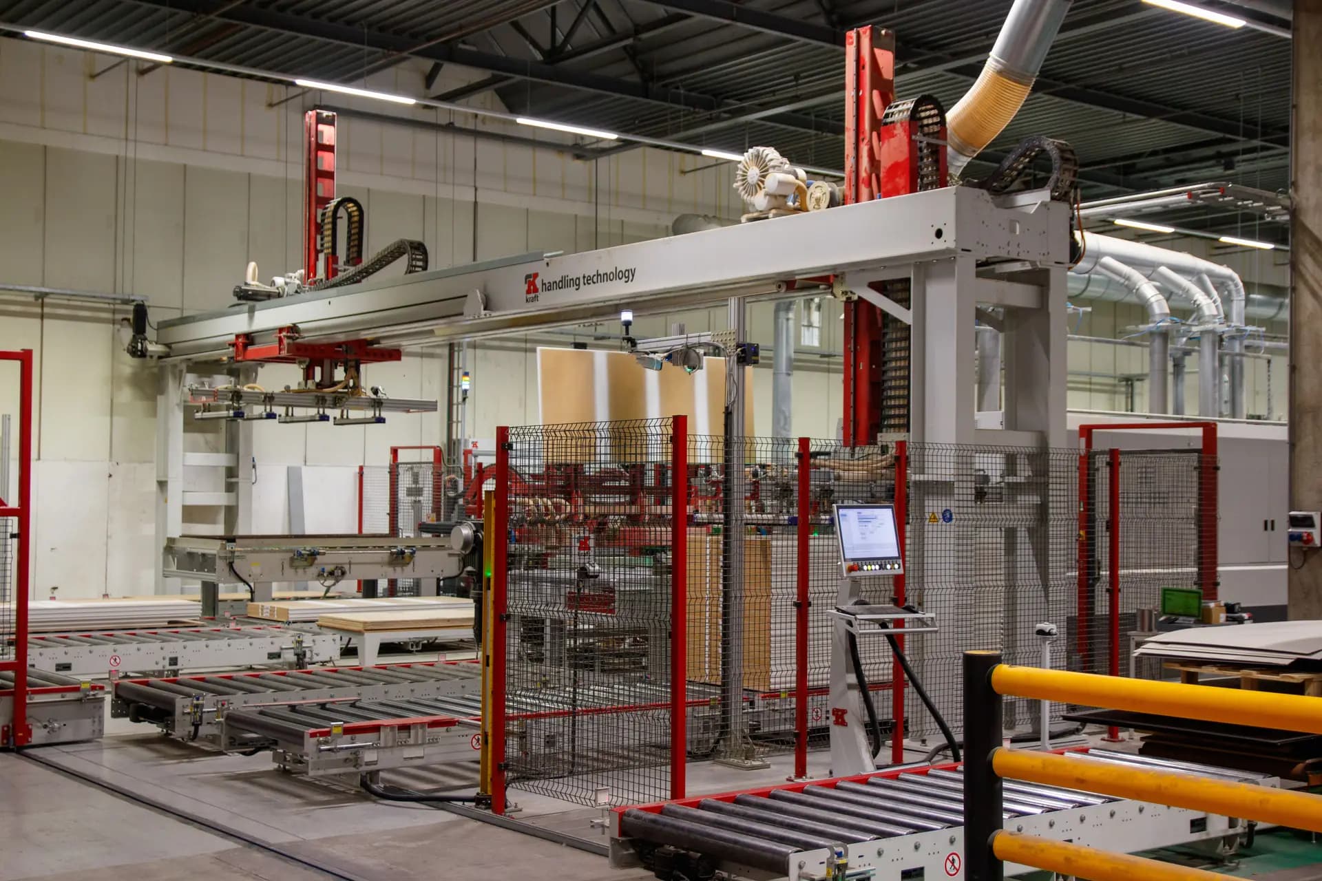 Automated conveyor and stacking line running through an industrial plant hall