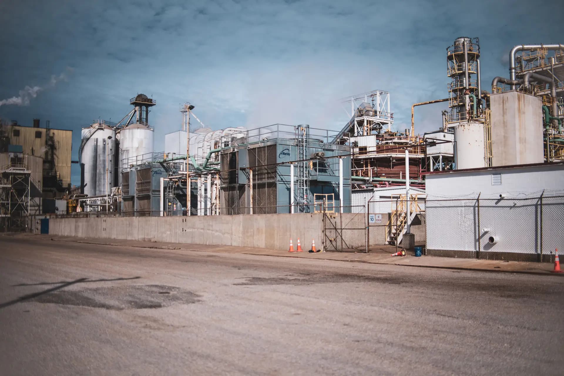 Wide view of an industrial processing plant with storage tanks, pipework and towers