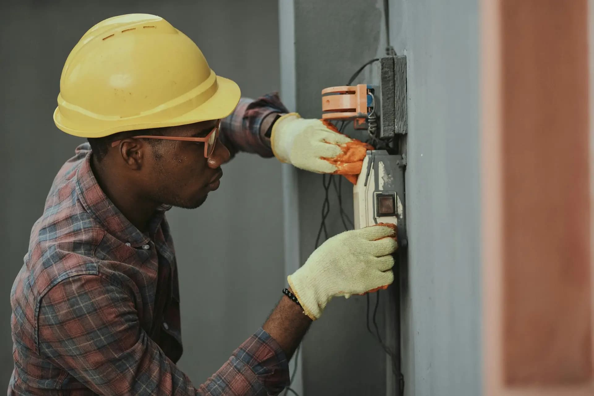Electrician in a hard hat working on wiring