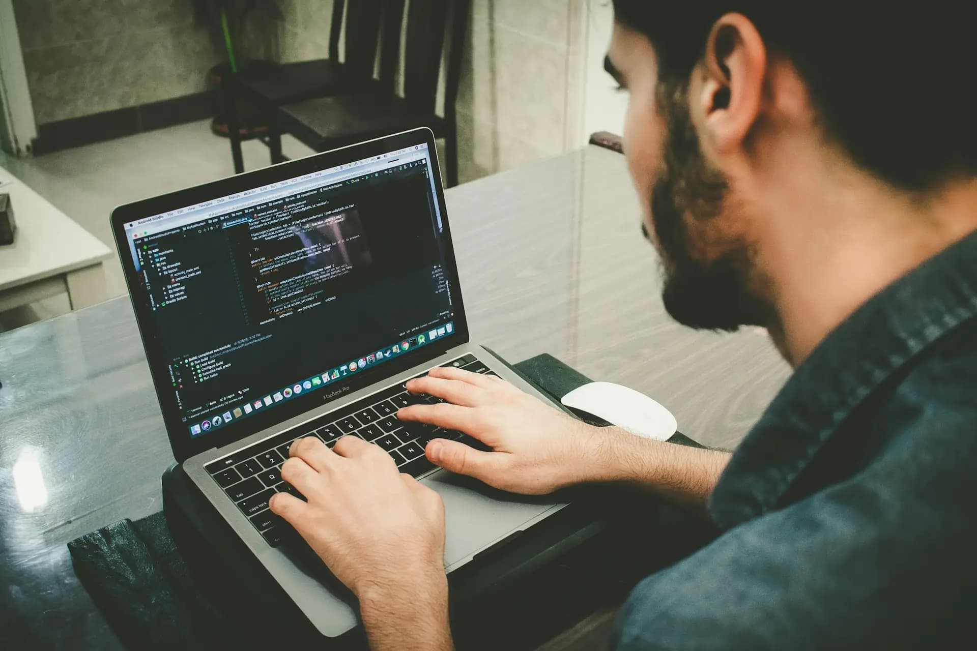 Engineer writing code on a laptop