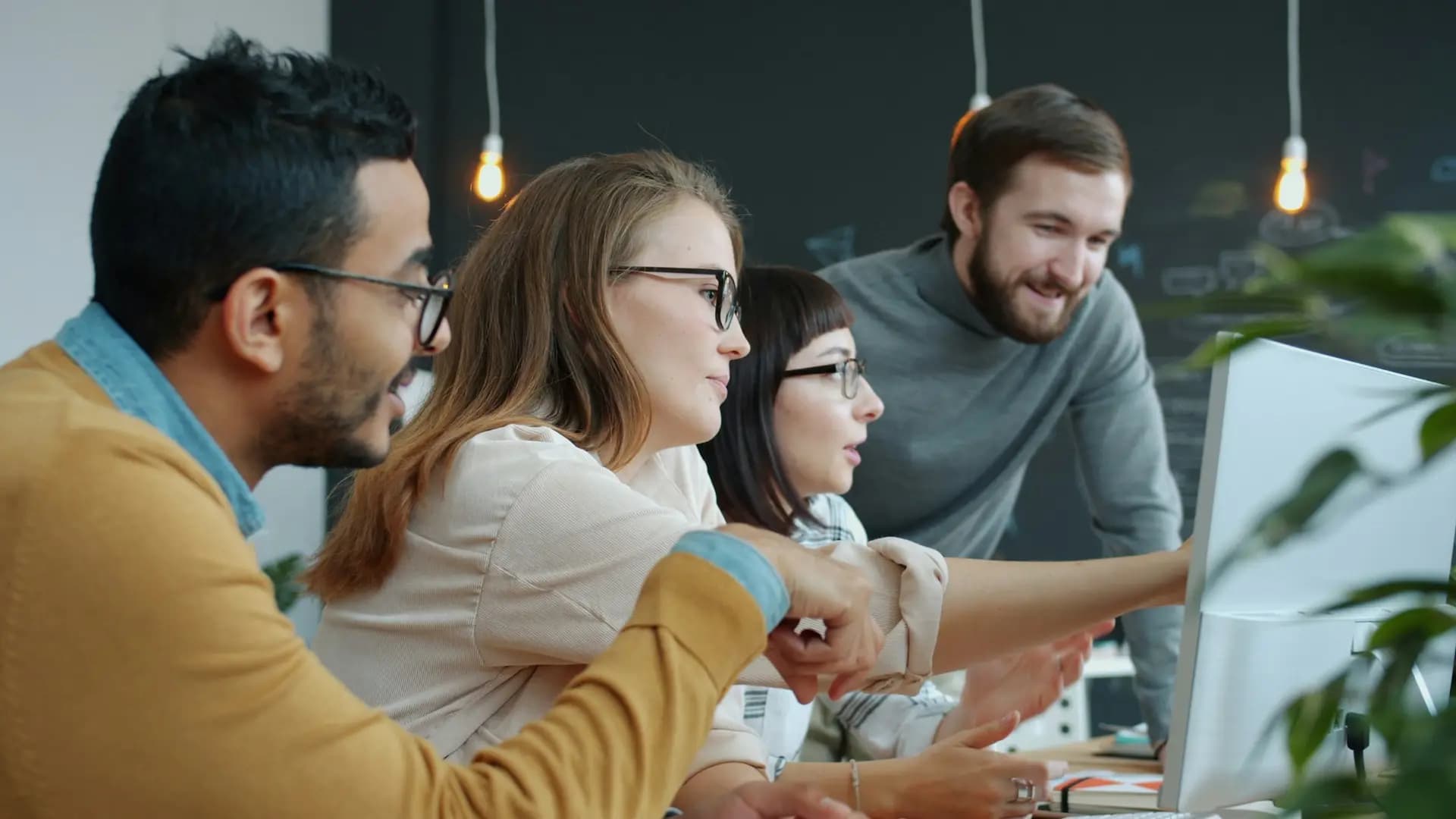 Team working together around a computer screen