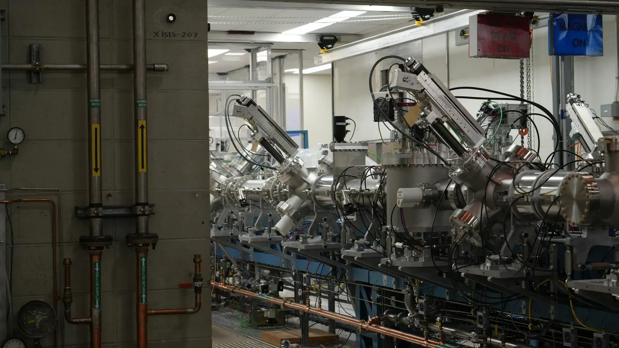 A row of automated machinery in a modern production facility, the kind of line a controls engineer commissions and supports